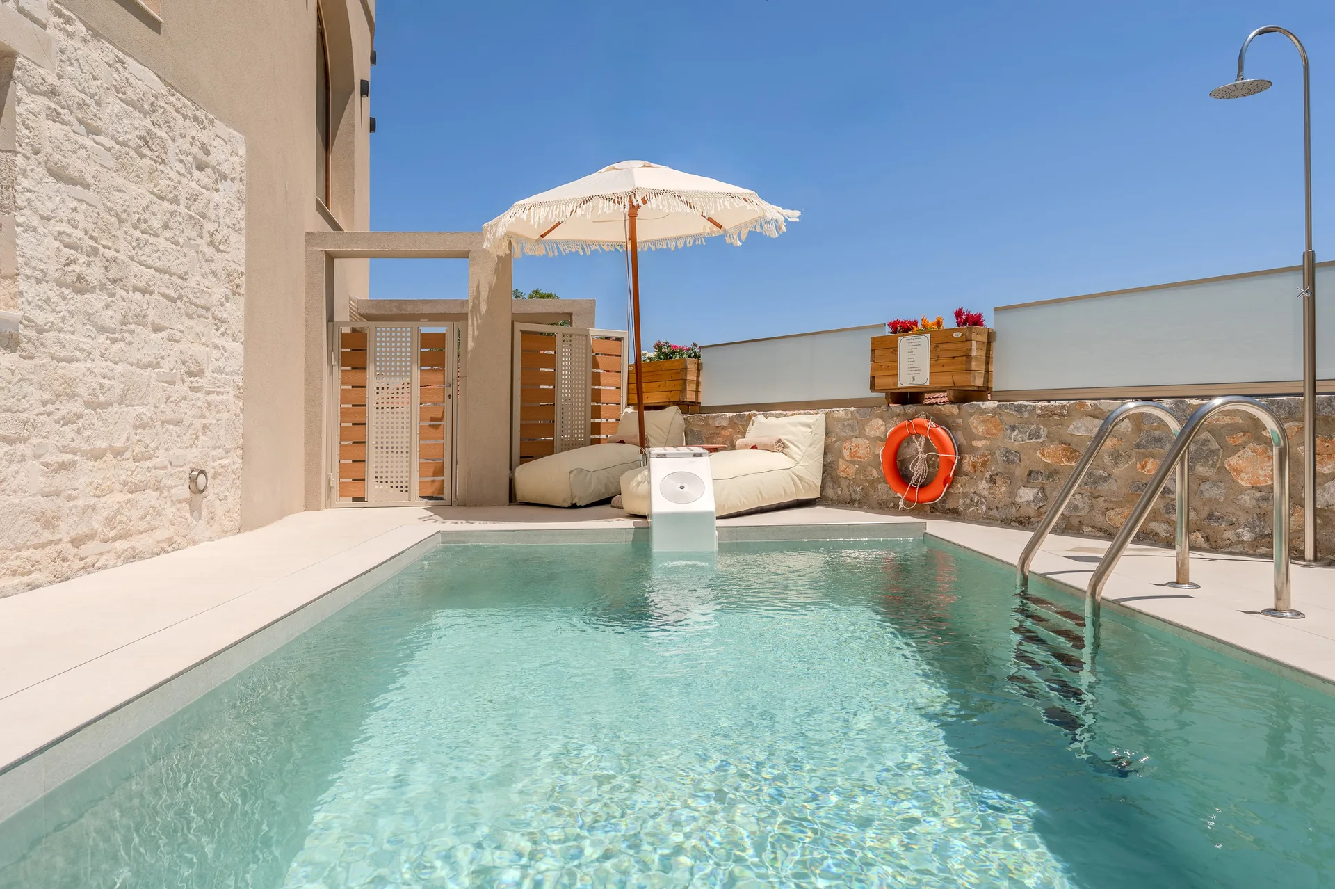Private pool beside the stone walls of Casa Karinea